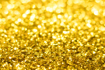 Gold glitter texture. Festive sparkling sequins background. Wpaper for Valentine, New Year or Christmas Holidays.