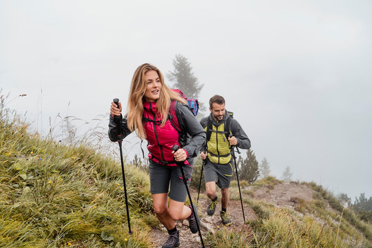 Young couple on a hiking trip in the mountains, Herzogstand, Bavaria, Germany
