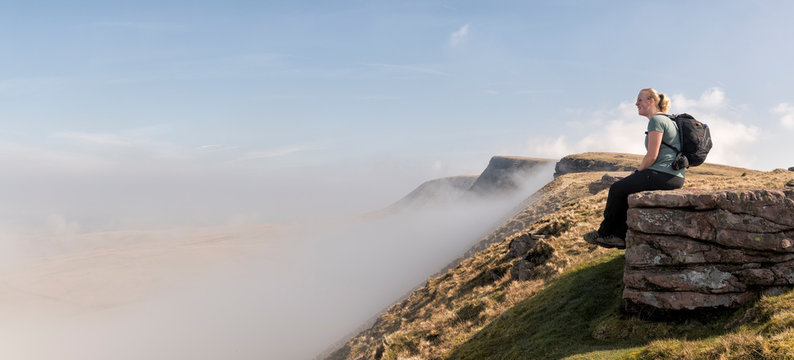 UK, Wales, Brecon Beacons, Young woman hiking at Bannau Sir Gaer Ridge