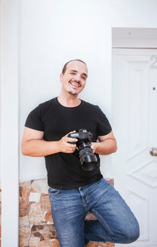 Portrait of smiling man holding a camera