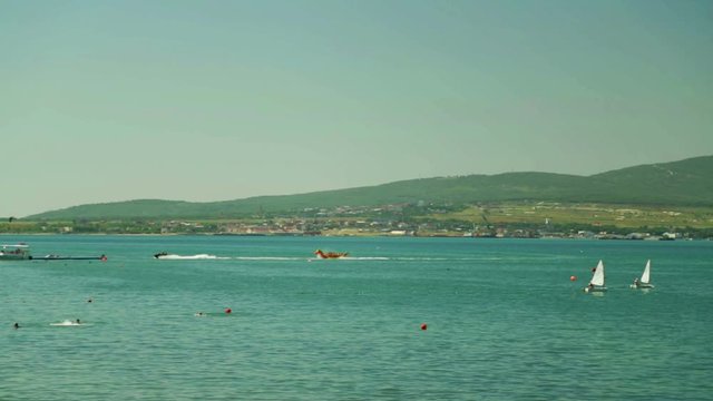 Small sailboats and yachts sail in the sea