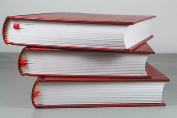 Heap of three red books on a table