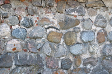 The image of an ancient wall of boulders and bricks as the background