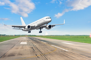 Fototapeta na wymiar Passenger plane lands on runway at airport.