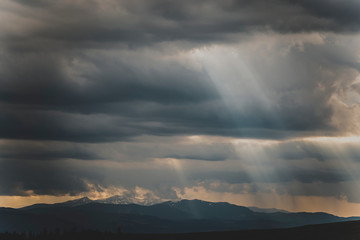 White mountain peaks in sun rays in afternoon