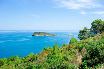Beautiful cozy bay with boats and clear turquoise water in Italy