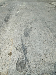 footprints on a grey concrete floor showing an advance