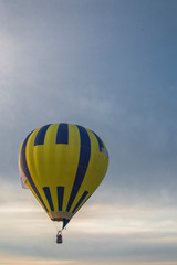 Hot air balloon raises in the sky