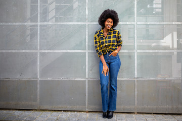 Full body stylish young african american woman with afro smiling