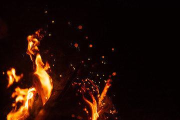 Beautiful abstract background on the theme of fire, light and life. Burning red hot sparks fly from...