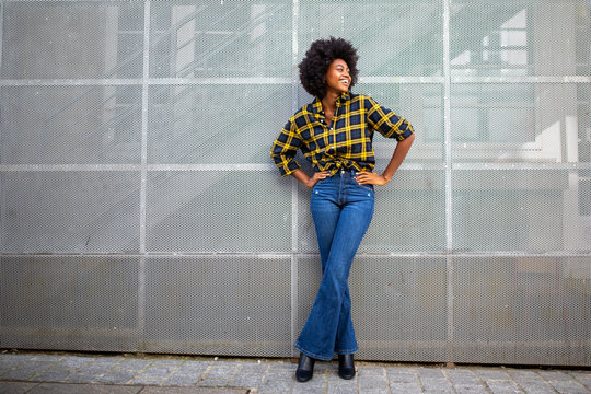 Full body fashionable young african american woman with afro smiling