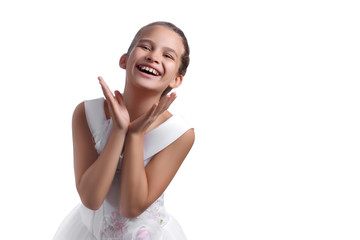 Cute pretty european little girl in white dress cheerfully laughing with empty space for text isolated on white background