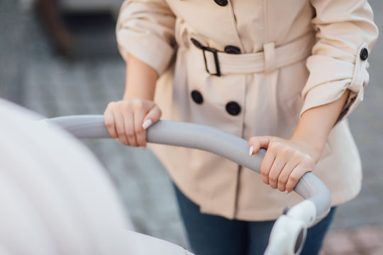 Close Up Photo, Woman Hands Holding Baby Stroller.