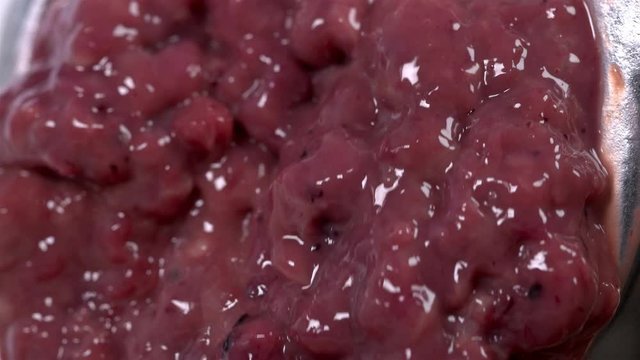 pieces of the liver come out through the holes in the meat grinder when scrolling, it looks very nasty and it looks like the human intestines are scrolling, close-up