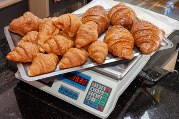 Measuring weight of bakery goods at shop