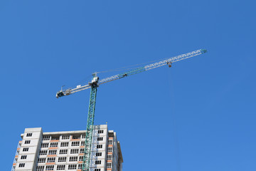 Bottom view of the multi-storey house and construction crane.