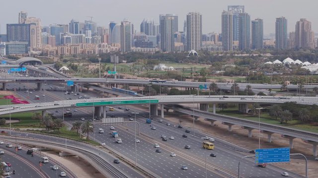 Dubai Golf Course with a cityscape of Gereens and tecom districts at the background aerial view. Traffic on sheikh zayed road with junction