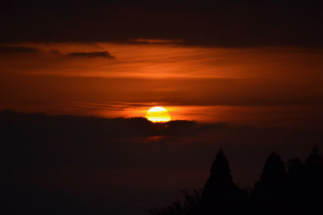 the dawn sunrise spreading hues of orange in the sky
