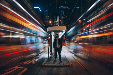 Time lapse photography of man standing in the middle of the street