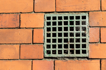 Grid block in a brick wall