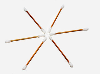 Ear sticks close-up on a light background laid out in the form of the sun