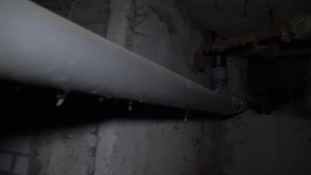 man runs through an old abandoned building, basement with lantern.