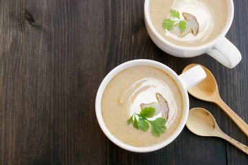 Homemade diet mushroom soup on a dark background.