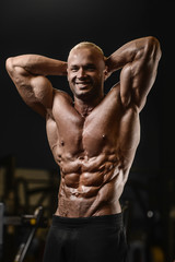 Fototapeta na wymiar Handsome strong athletic men pumping up muscles workout fitness and bodybuilding concept background - muscular bodybuilder fitness man doing abs exercises in gym naked torso.