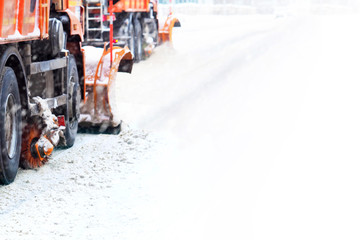 Snow removal in winter. Snow plough trucks clearing road during  winter snowstorm blizzard....