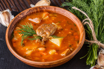 Chanahi a traditional Georgian meat stew in a bowl on stoyn board