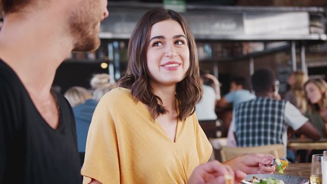Couple On Date Meeting For Drinks And Food In Restaurant
