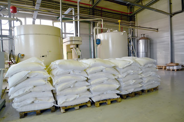 Bags of sugar are stored in the production shop of the chocolate factory