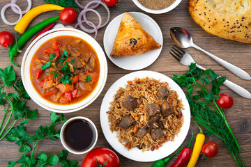 Assorted Uzbek food set, pilaf, samsa, lagman, manta, shurpa Uzbek restaurant concept, Uzbek
