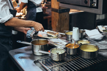 Unrecognizable chef cooking food in a restaurant kitchen