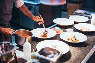 Obraz na płótnie Canvas Professional chef serving food on plates