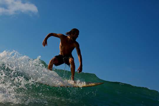 Male Surfer Riding Ocean Wave