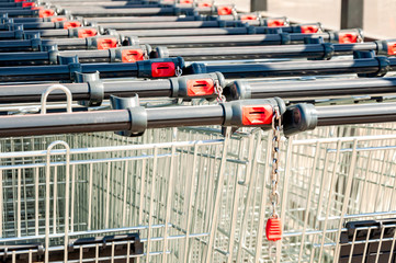 Shopping carts in the store, assembled in a row in the parking lot. Close-up.