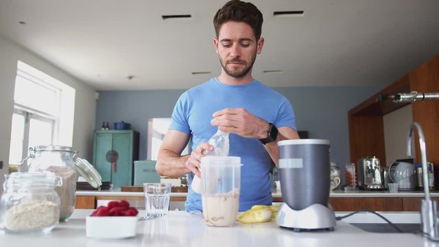 Man Making Protein Shake After Exercise At Home