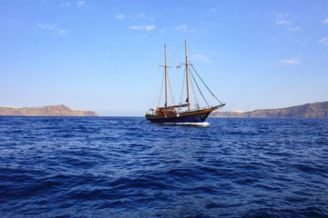 A ship sailing along the coast of Santorini