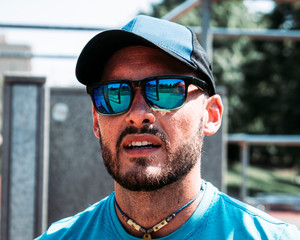 Portrait of a young attractive man outside with sunglasses