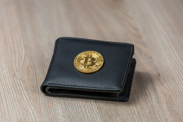 Cryptocurrency Bitcoin coin in a leather wallet