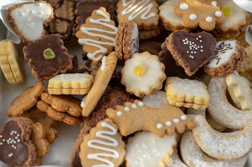Many kinds of Christmas cookies in one pile in the box, various colors and tastes