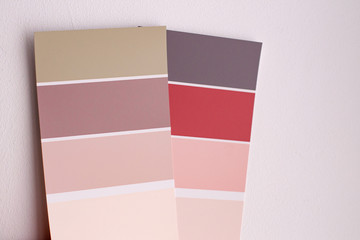 Color palette with various samples. Light background. Paint selection cards, close-up.
