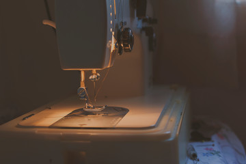 Needle on sewing machine while sewing clothes.