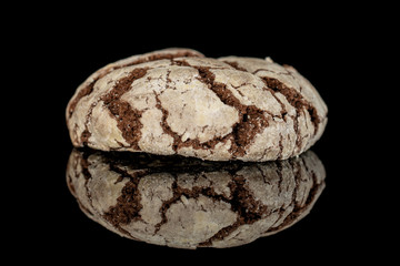 One whole baked chocolate brownie cookie isolated on black glass