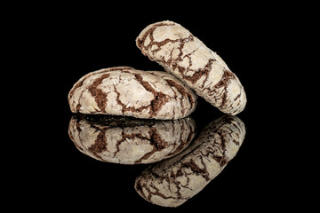 Group of two whole baked chocolate brownie cookie isolated on black glass