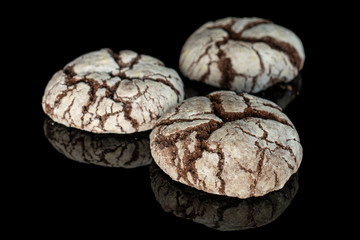 Group of three whole homemade baked chocolate brownie cookie isolated on black glass