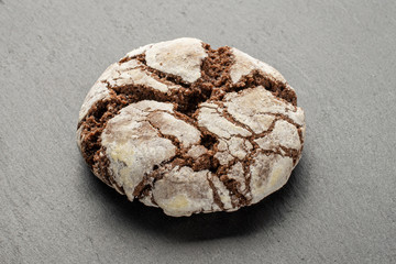 One whole baked chocolate brownie cookie on white background