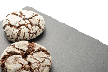 Group of two whole baked chocolate brownie cookie on grey stone isolated on white background