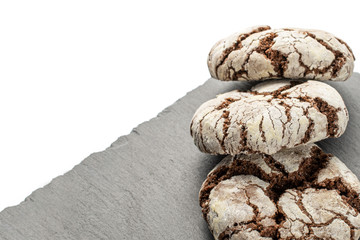 Group of three whole baked chocolate brownie cookie on grey stone isolated on white background